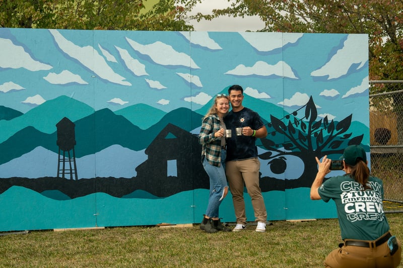 A couple poses for a photo at the 2 Towns Ciderhouse Harvest Party 2025.