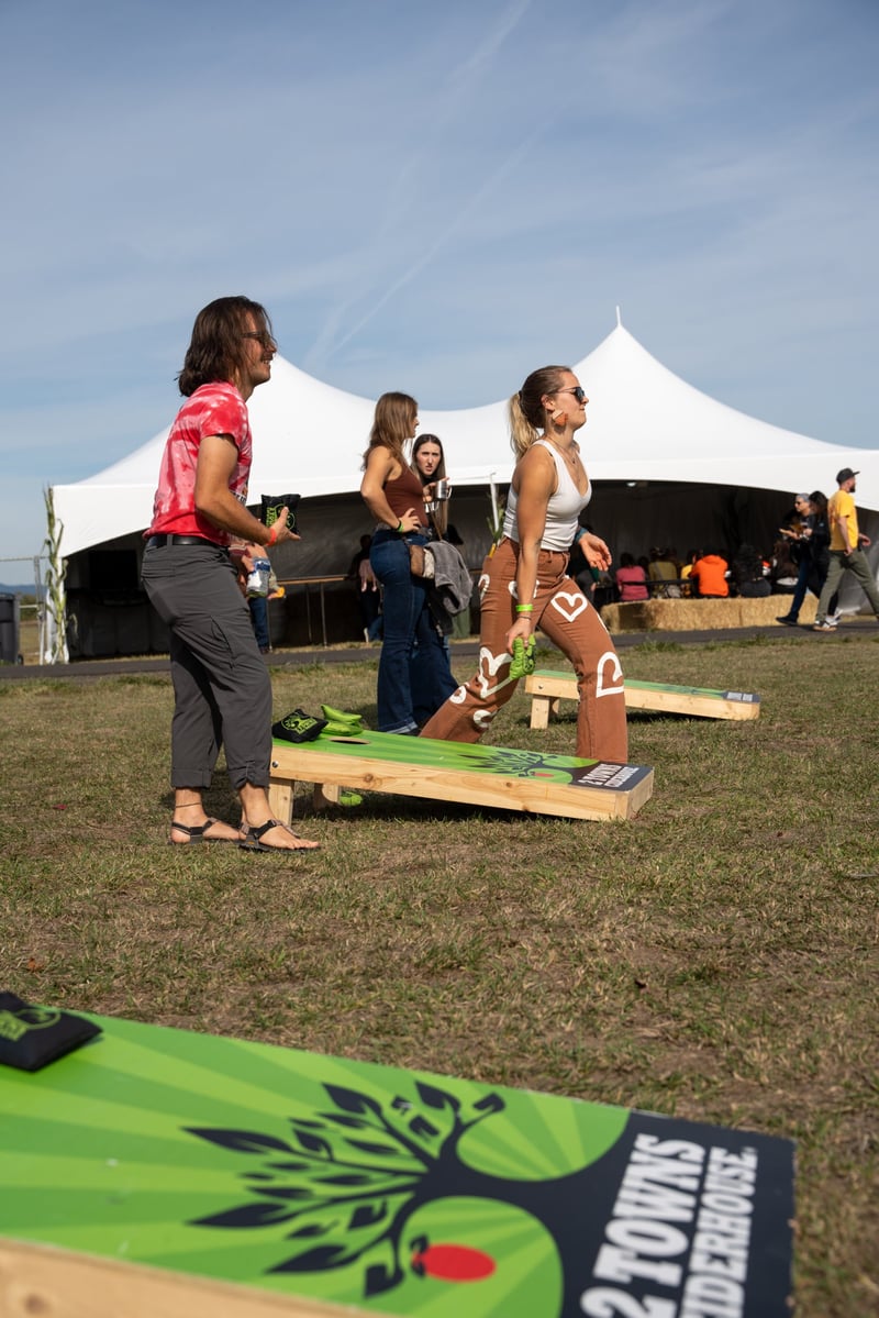 Participants enjoying a cornhole game at Harvest Party 2024.