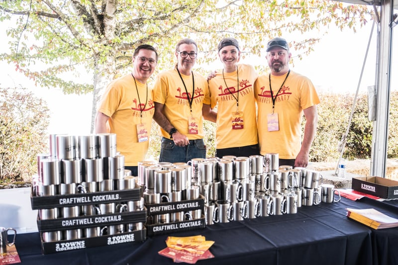 Four servers at the Harvest Party 2024 event, showcasing craft cocktails.