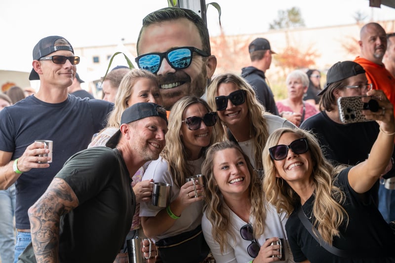A group of friends taking a selfie at Harvest Party 2024.