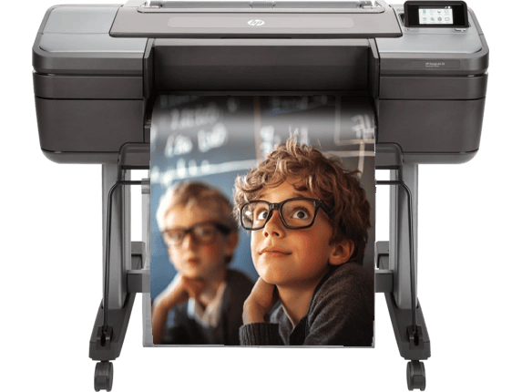 A large-format printer with a poster of two young boys wearing glasses, one focused and the other blurred in the background