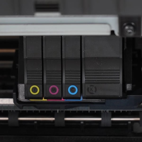 Close-up of ink cartridges in a Poster Studio Express poster printer machine