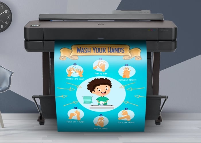 Large poster printer machine printing a colorful "Be Thoughtful" class values poster with children's images.