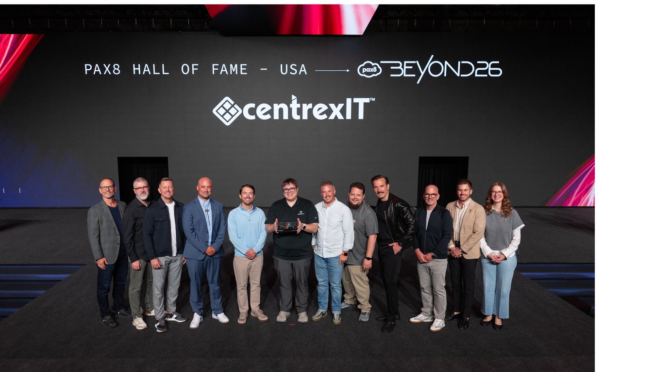 The centrexIT team on stage at Pax8 Beyond 2026 in Salt Lake City, with the Pax8 Hall of Fame USA recognition for centrexIT displayed on the screen behind them