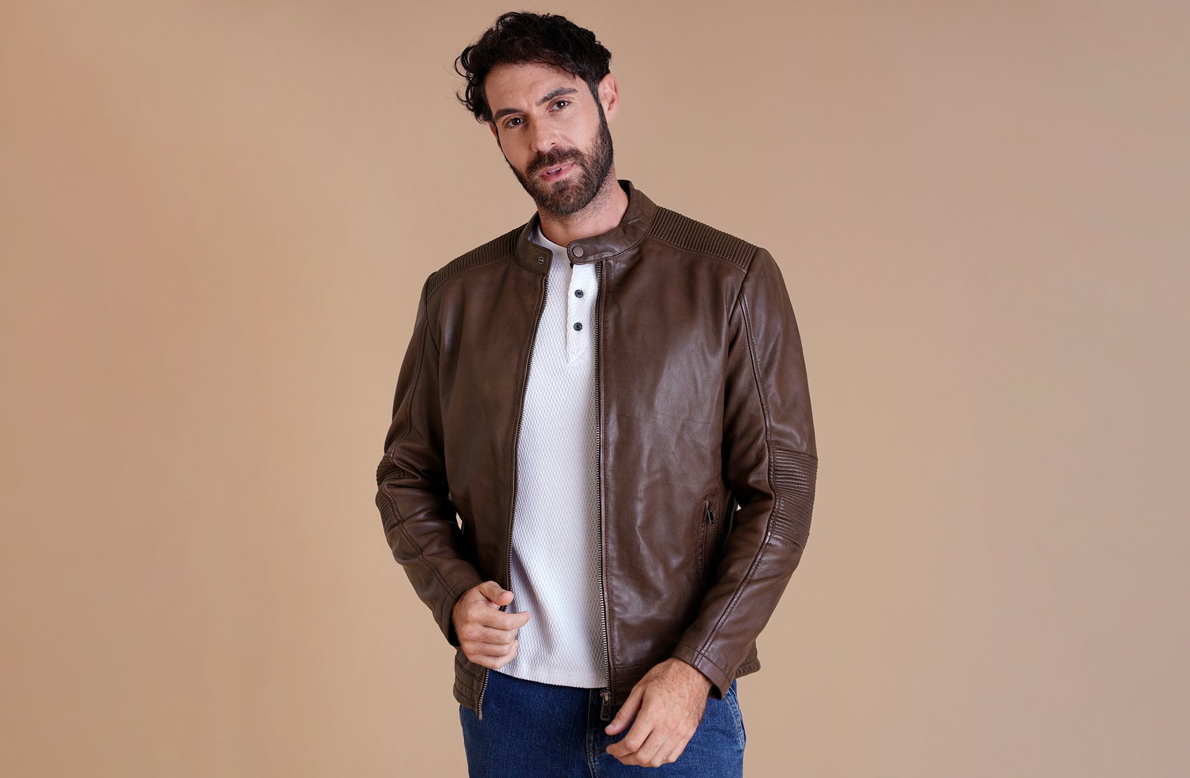 A man wearing a black leather jacket, demonstrating durability and long-term style and versatility.