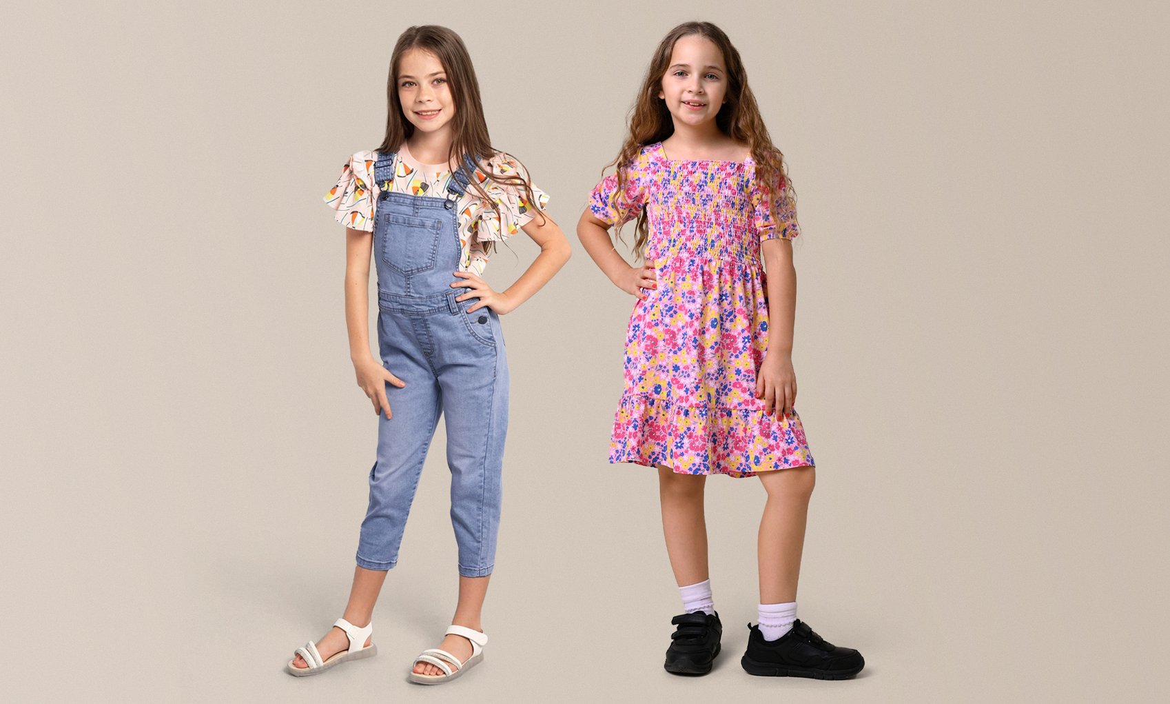 A young girl wearing a denim dungaree over a striped top.