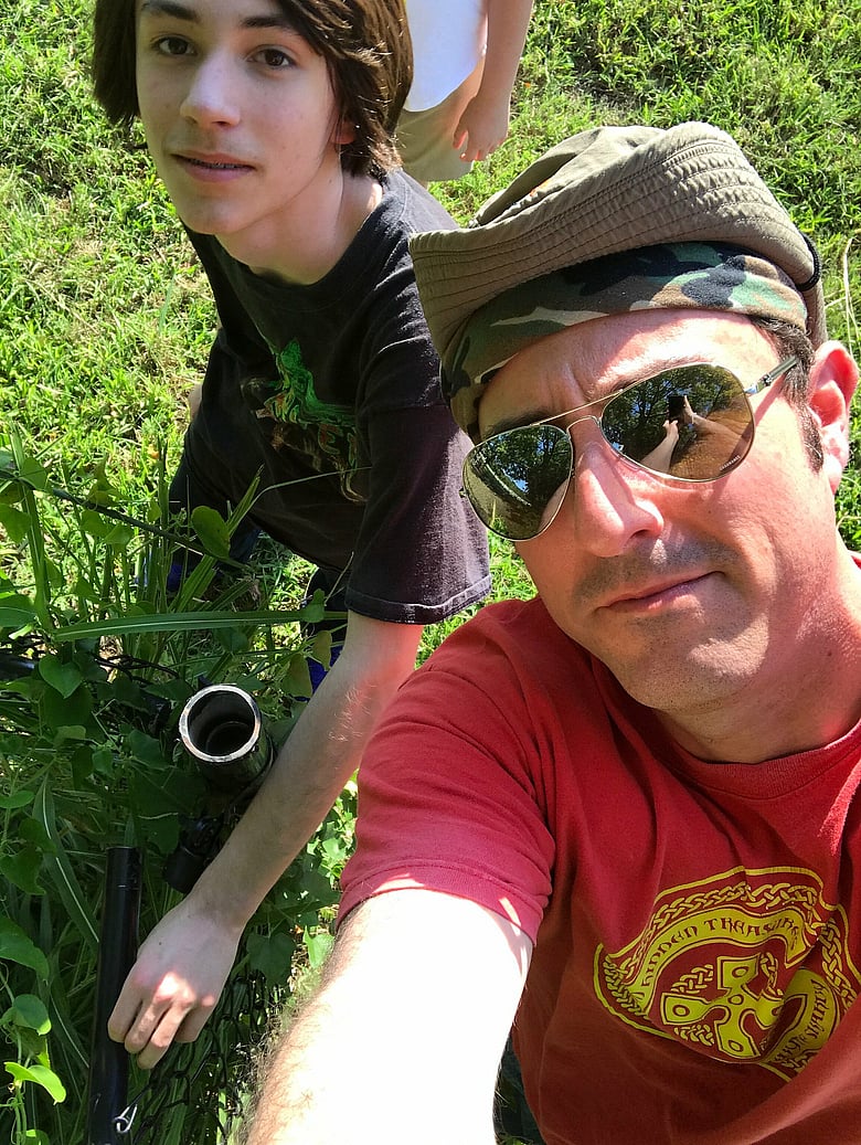 Looking for a cache at a metal fence