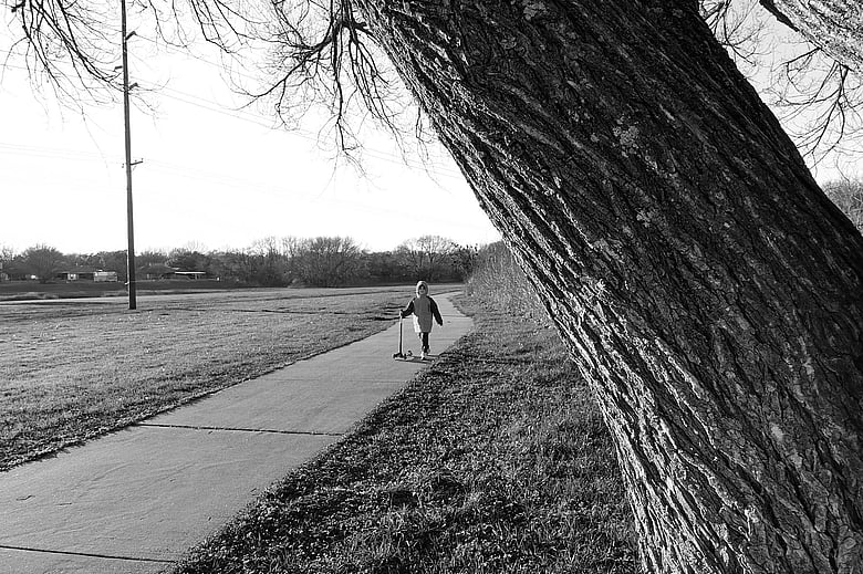 View of my son from behind the tree