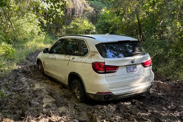 white BMW SUV stuck in the mud in a Palo Verde National Park, Costa Rica