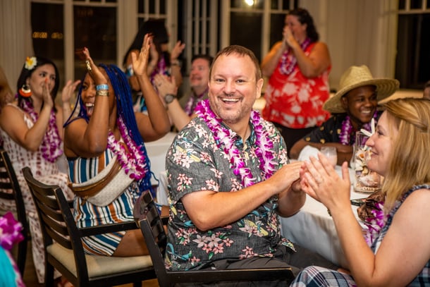 a group of people smilng and clapping