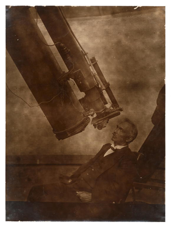 Photograph of New South Wales government astronomer W E Cooke with telescope