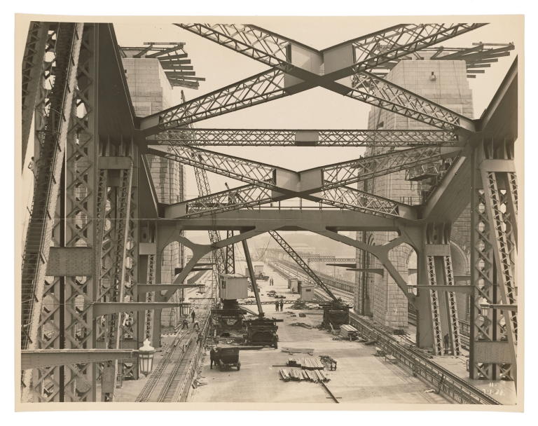 Photograph of the cranes and workmen on the central roadway of the Sydney Harbour Bridge
