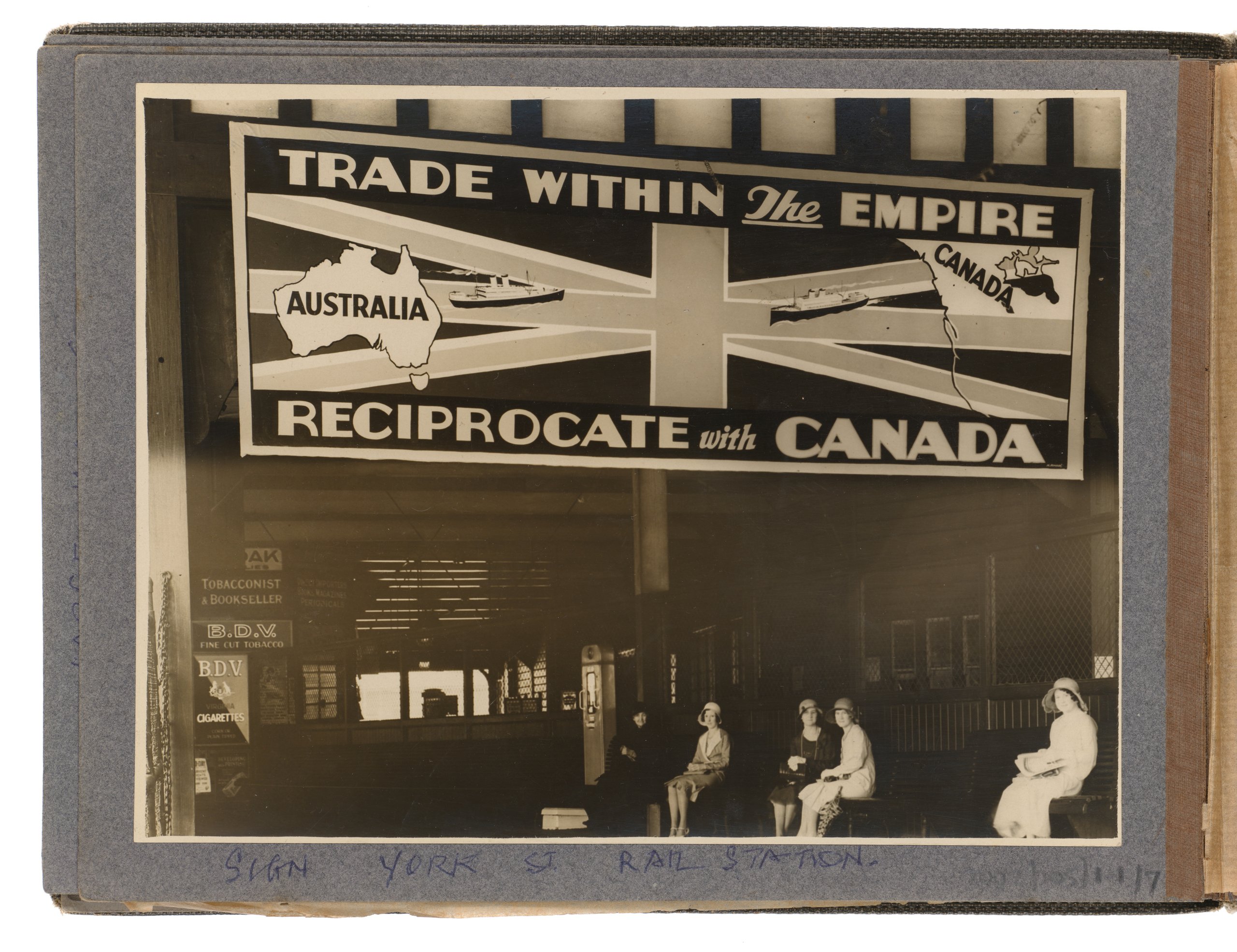 Photograph of advertising billboard at Wynyard Railway Station promoting trade between Australia and Canada