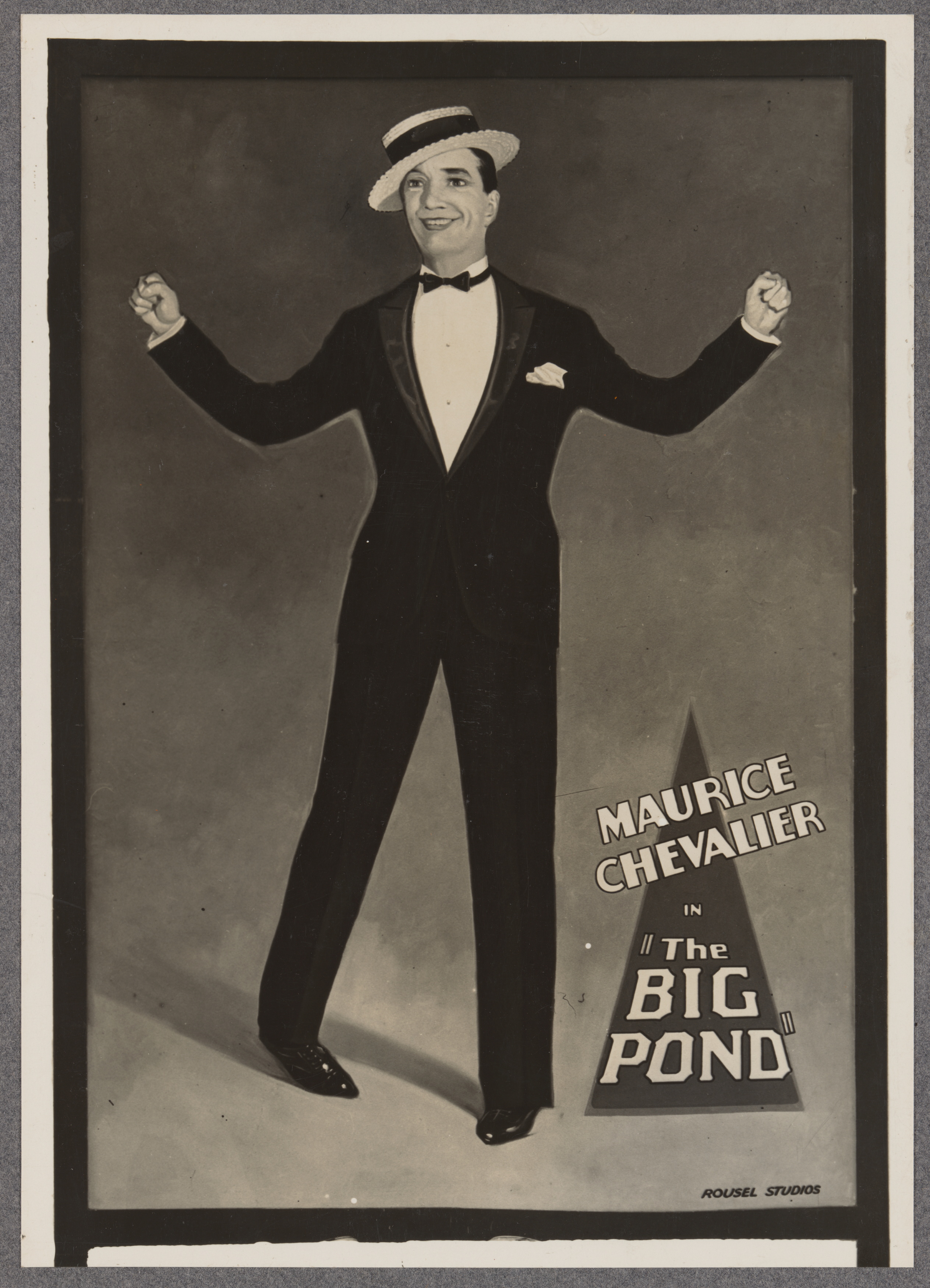 Photograph of large wall sign advertising the film "The Big Pond" starring Maurice Chevalier at the Prince Edward Theatre