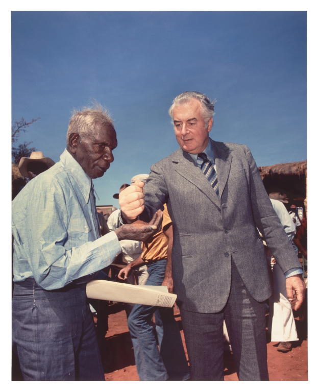'Gough Whitlam pouring soil into the hands of traditional owner Vincent Lingiari' by Mervyn Bishop