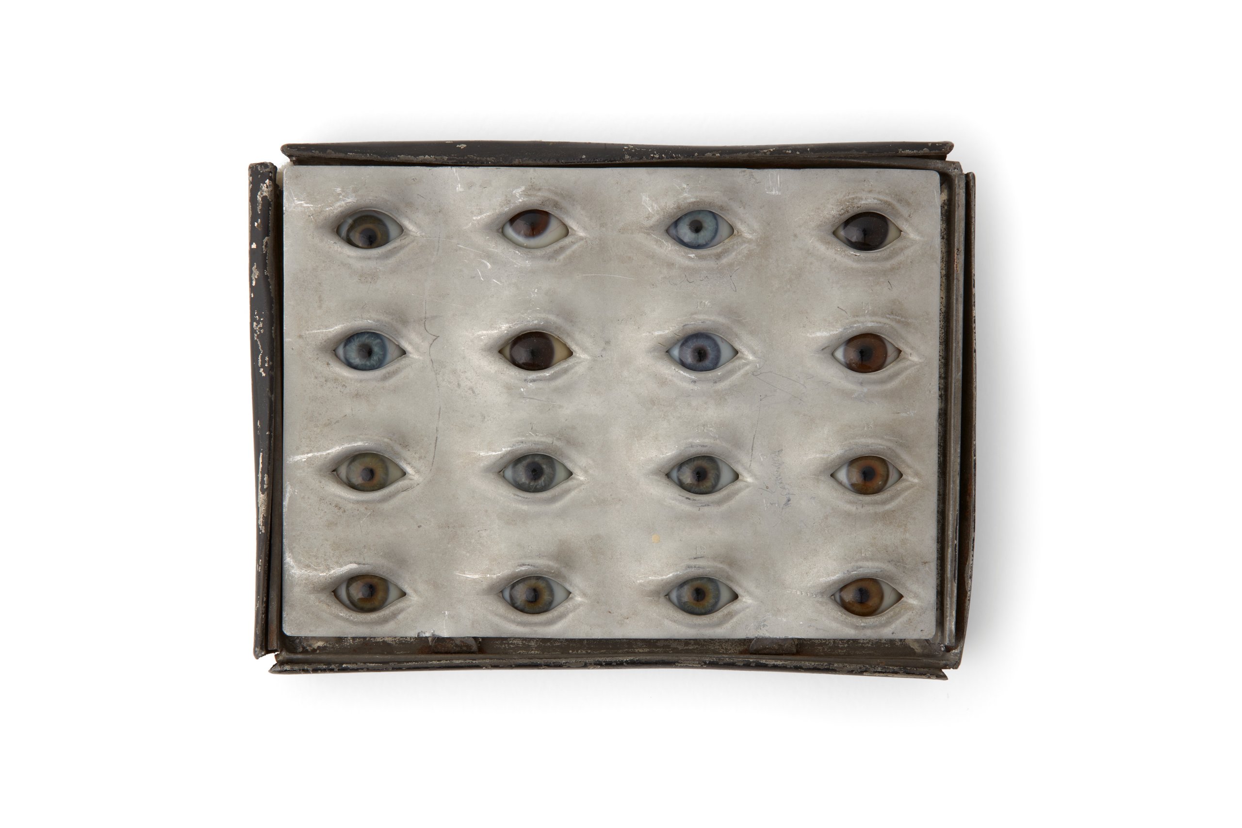 Glass eyes in a tin box by Rudolf Martin