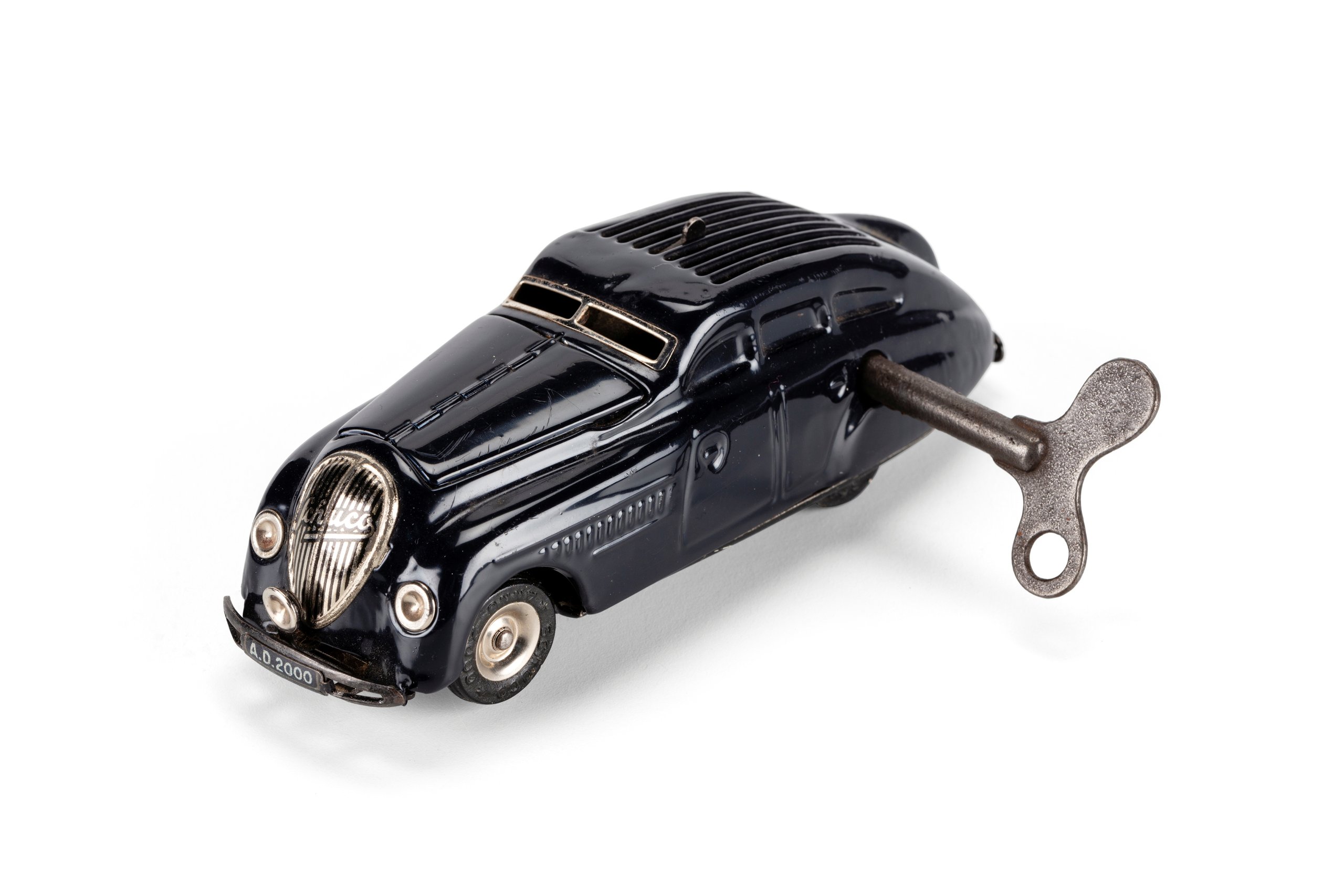 Clockwork 'Kommando Anno 2000' toy car with key made by Schuco