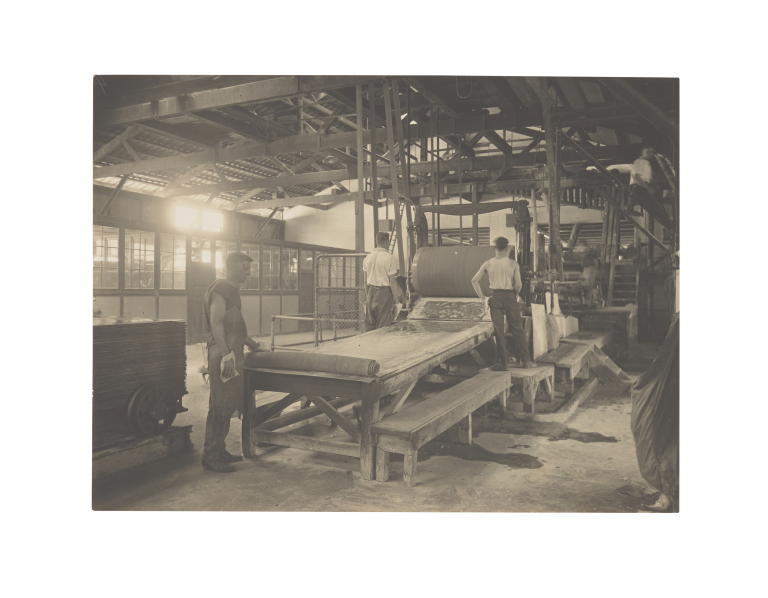 Photograph of workers rolling out Durabestos at the Wunderlich Cabarita factory