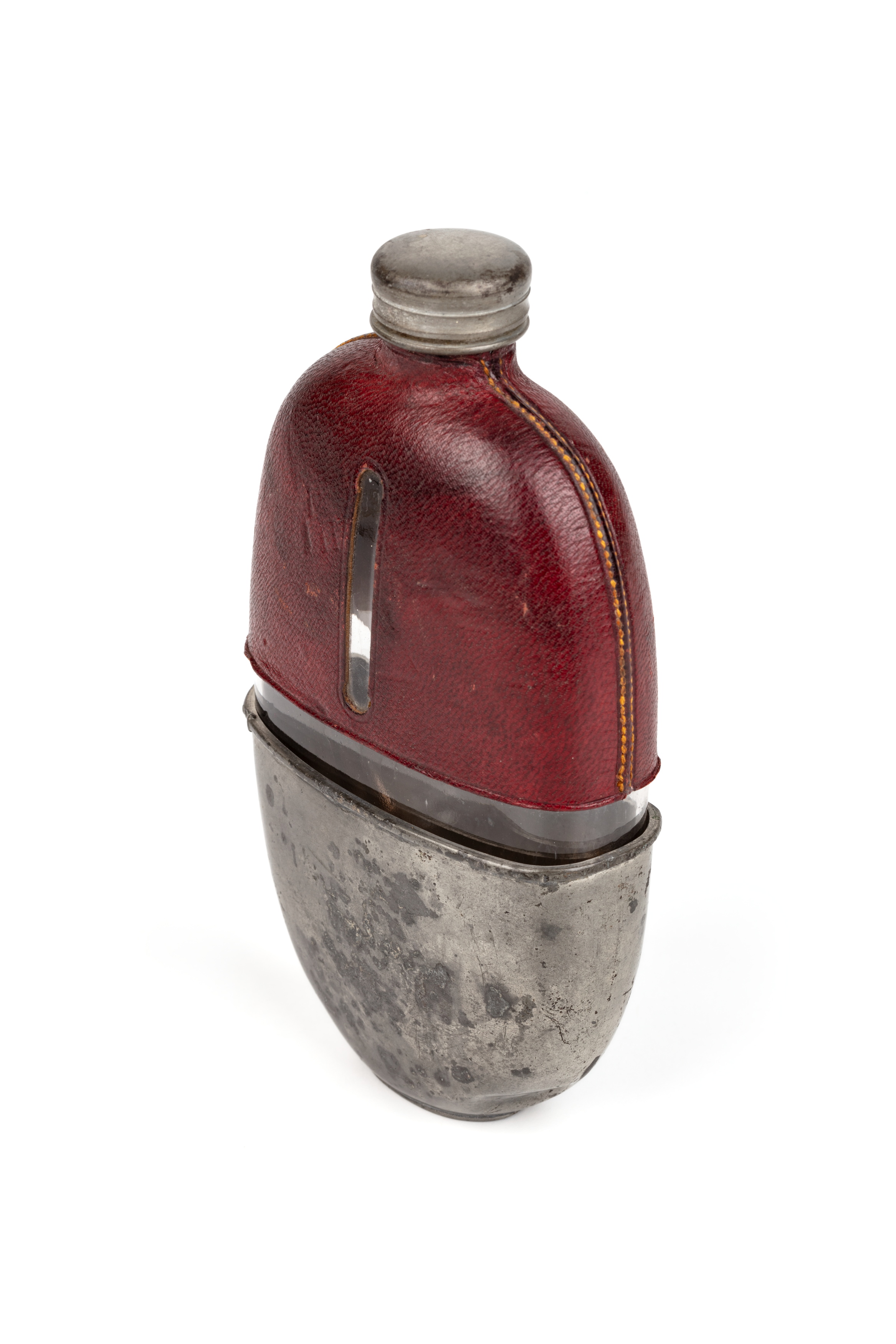 Oval shaped glass brandy flask with a red leather and metal cover