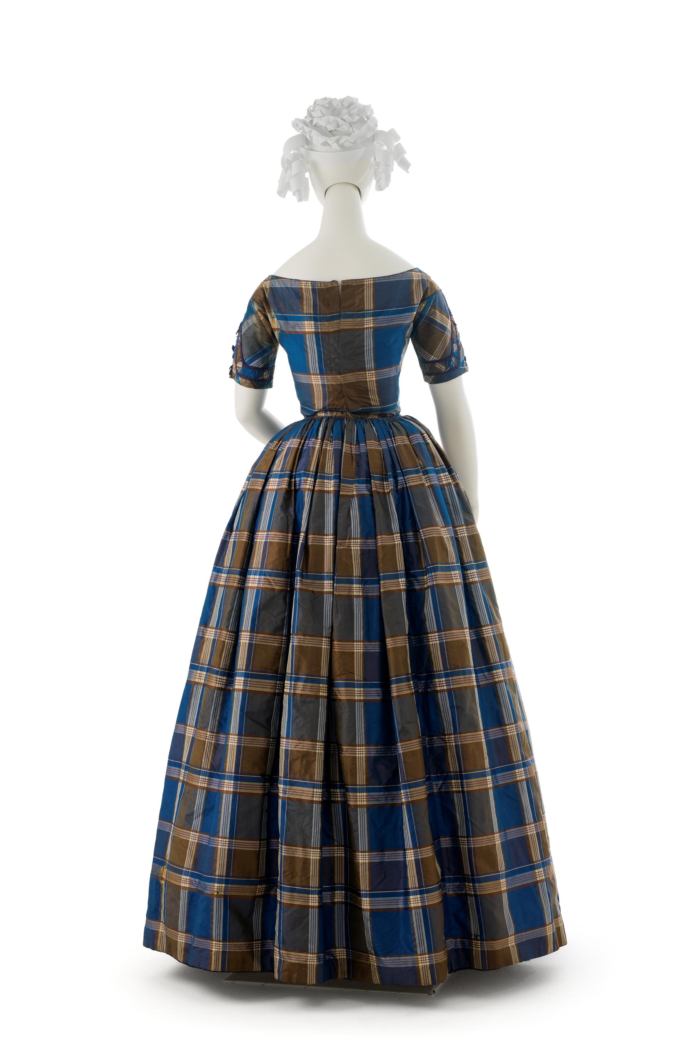 sachin and babi light blue dress Evening dress 1885 R. H. White & Co. American The bustle silhouette,  although primarily associated with the second half of the 19th century,  originated in earlier fashions as a simple bump at