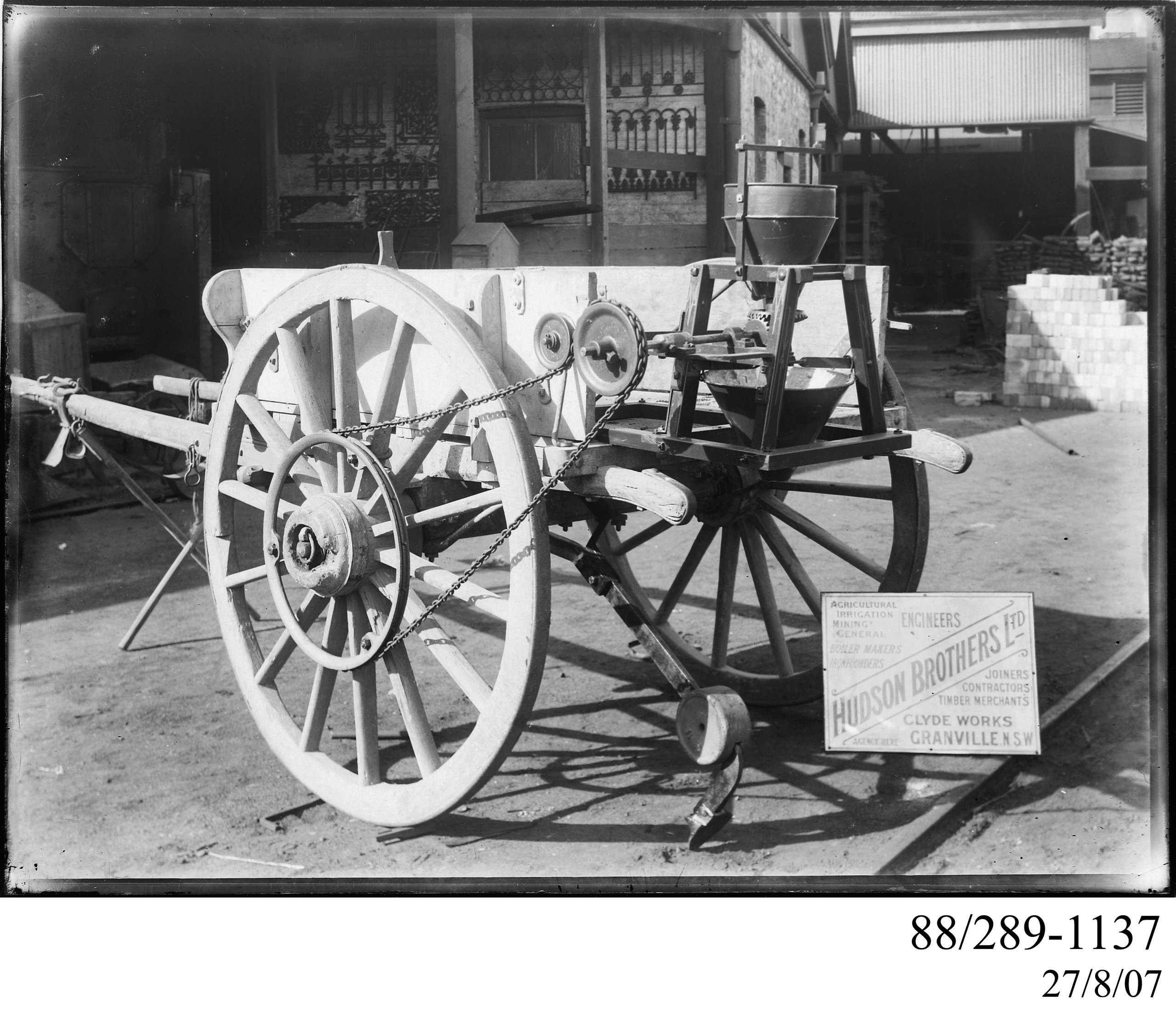 Glass plate negative of a Hudson Bros horsedrawn endgate seeder