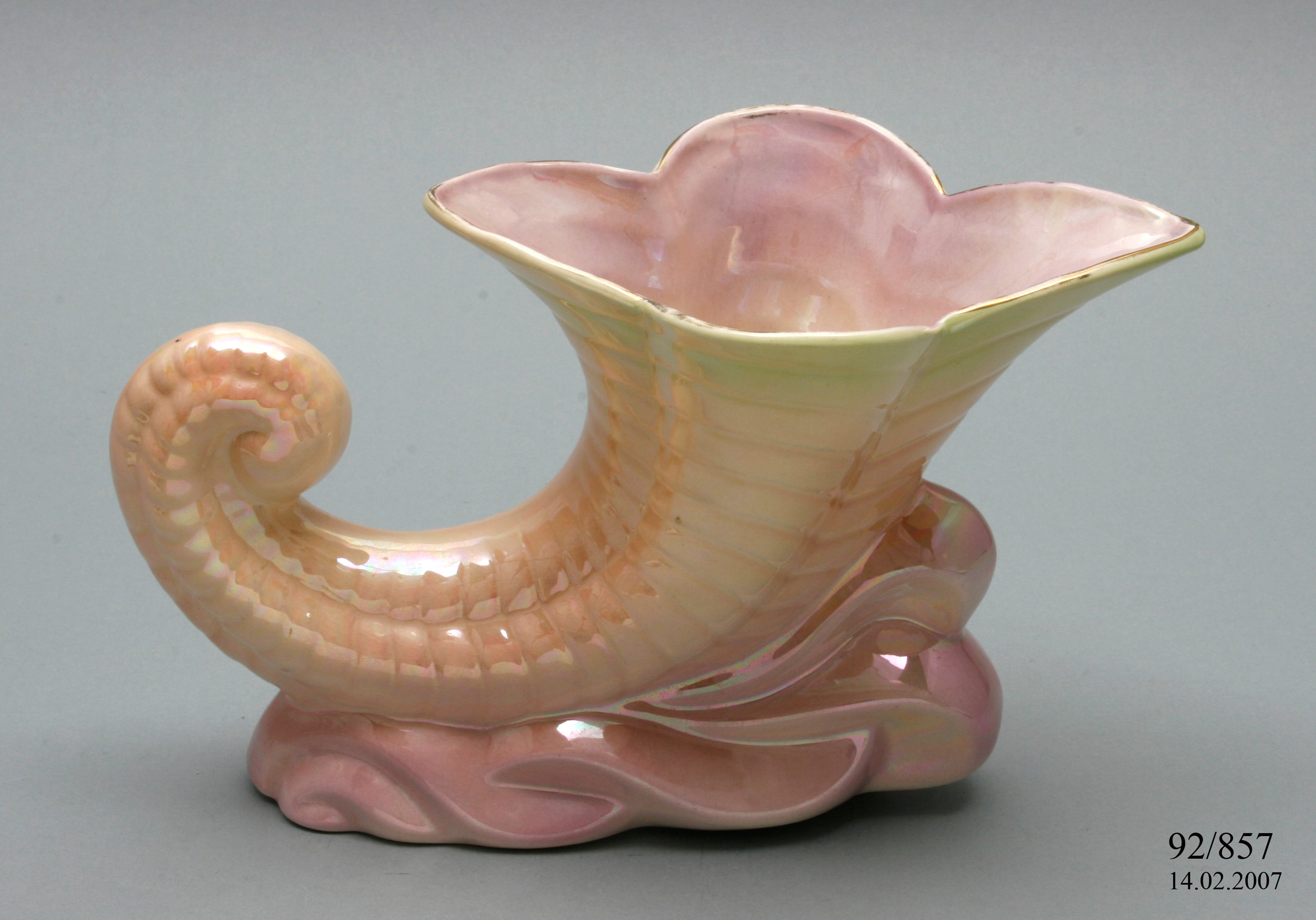 A Pates Potteries slip-cast cornucopia shaped vase.