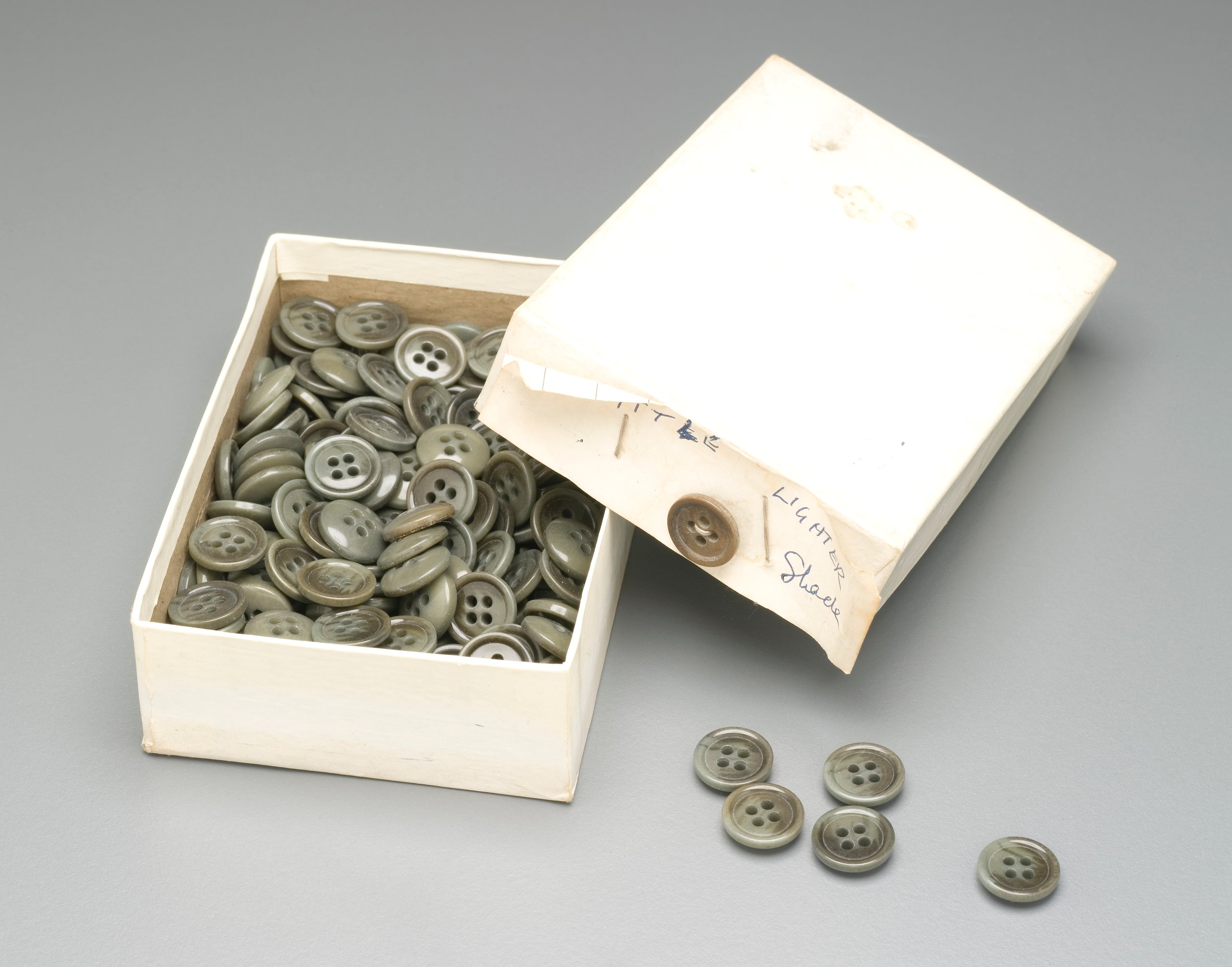 Box of buttons used by Ron and Maxwell Gillman