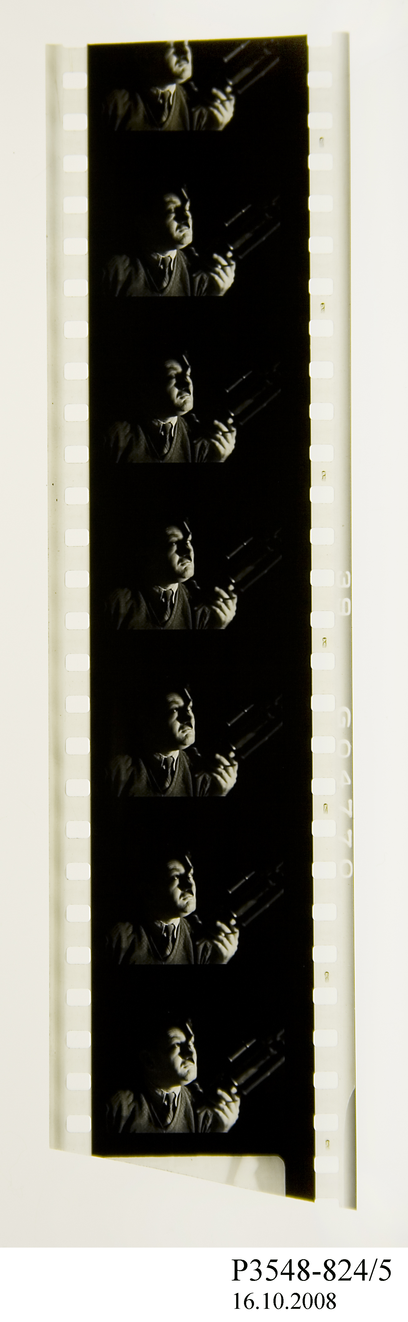 Film strip showing a man looking into a telescope