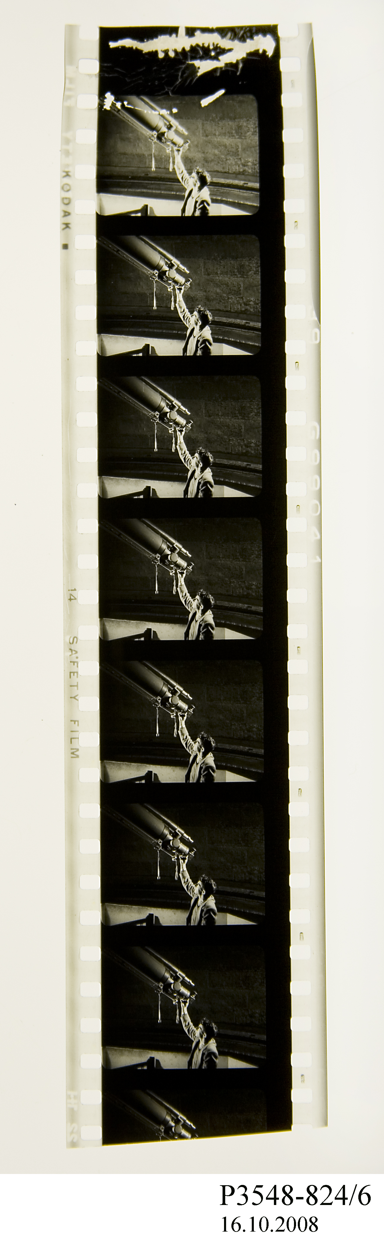 Strip of film showing a man adjusting a telescope
