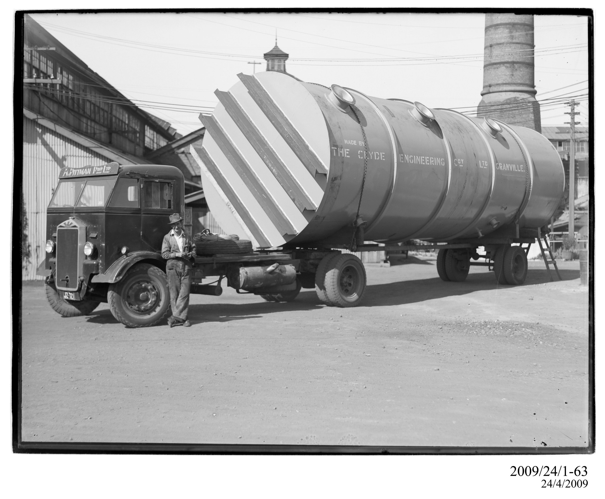 Large cylindrical vessel on A. Pittman 'Albion' articulated truck in works yard