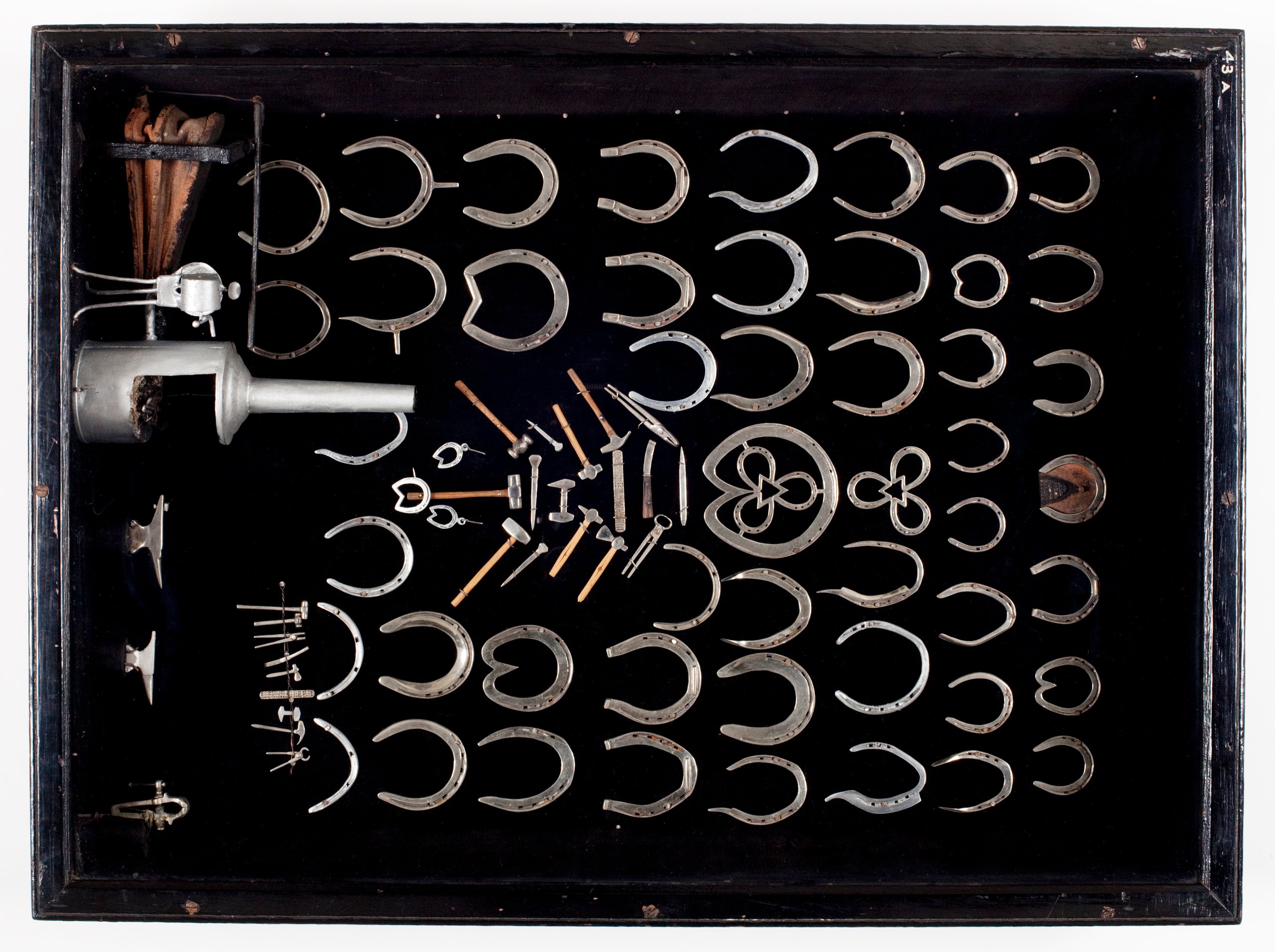 Miniature horseshoes and blacksmithing tools by Frederick Ivory