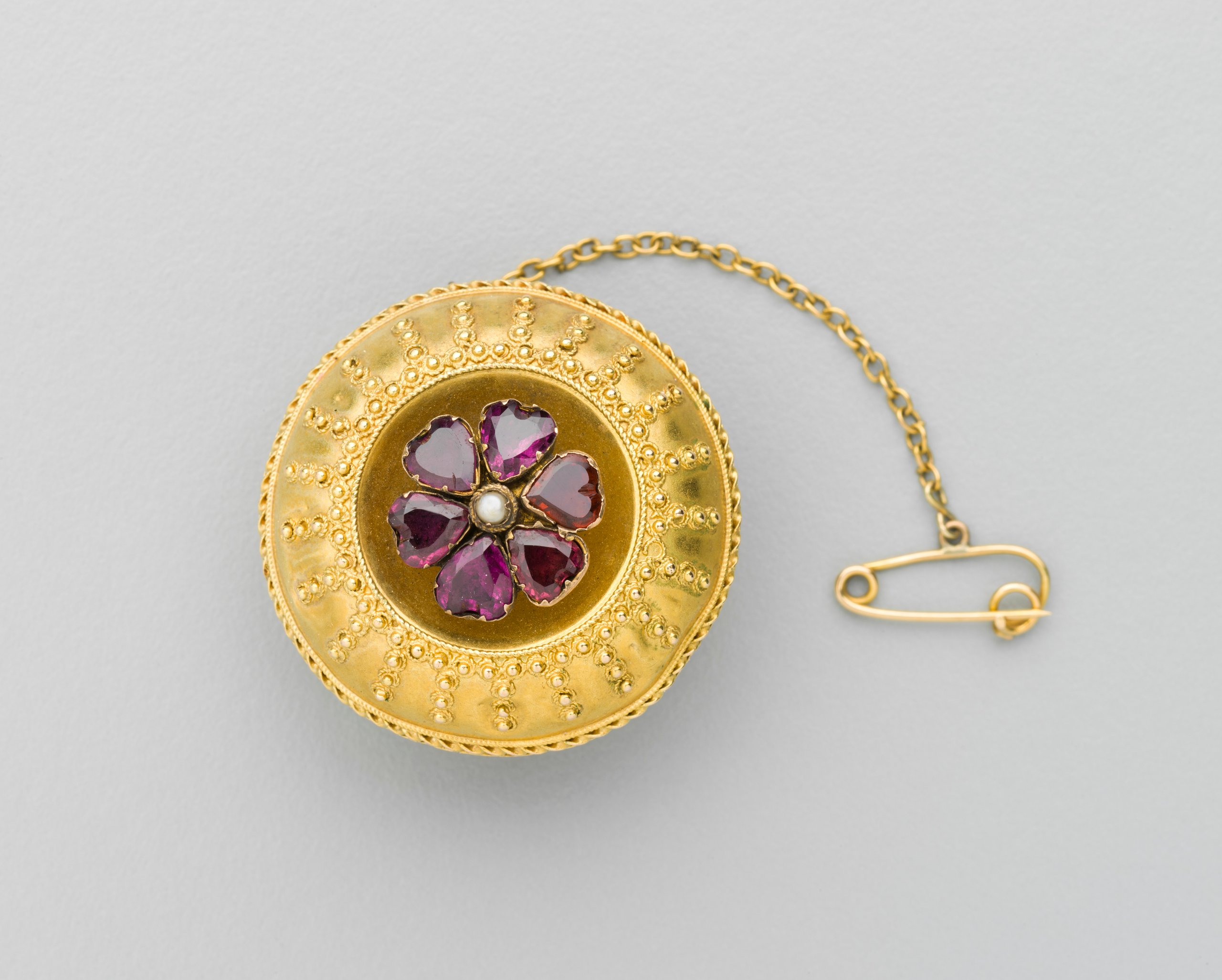 Gold brooch with amethyst and pearl decoration