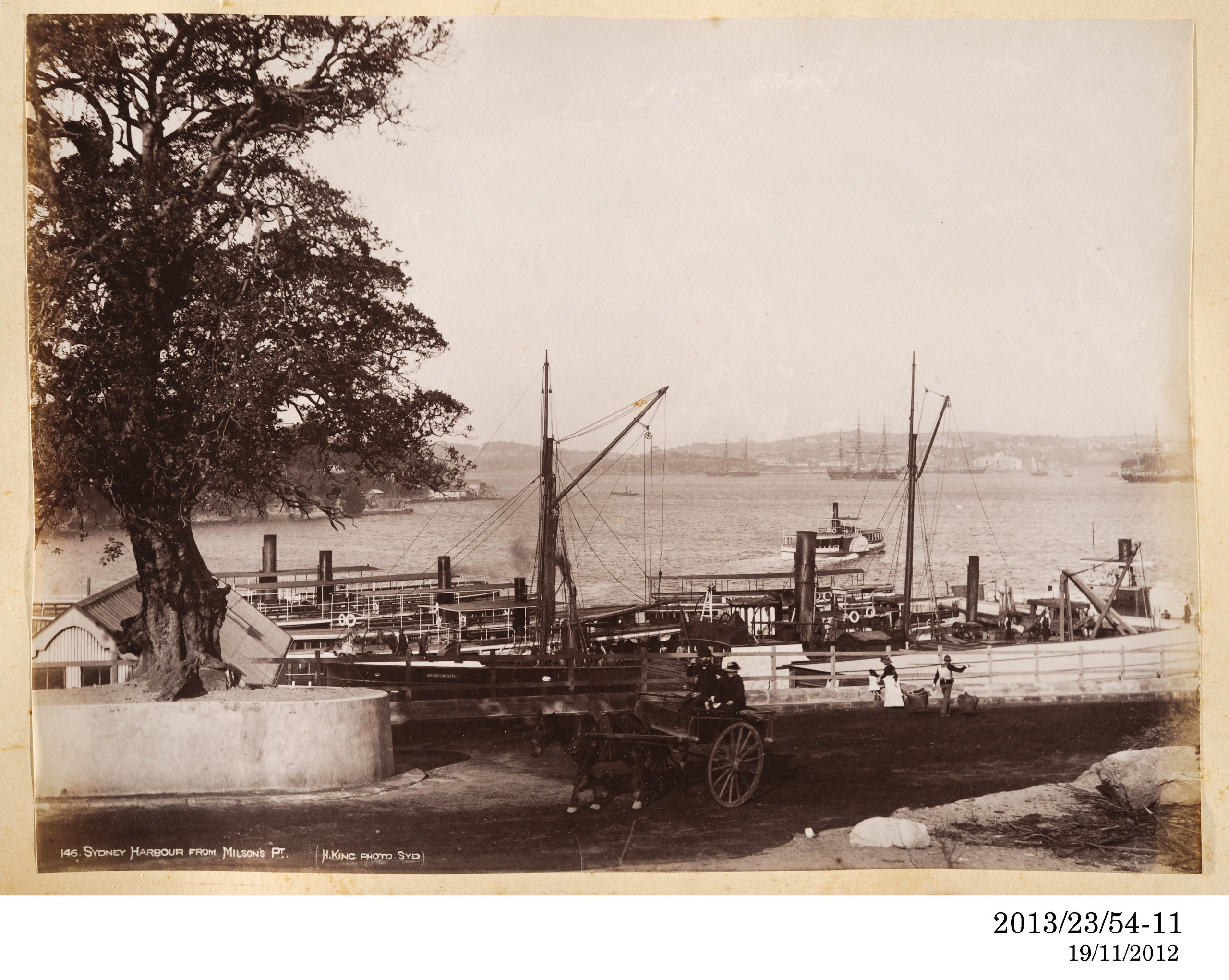 Photograph of ferries and a barge lined up at Milson's Point
