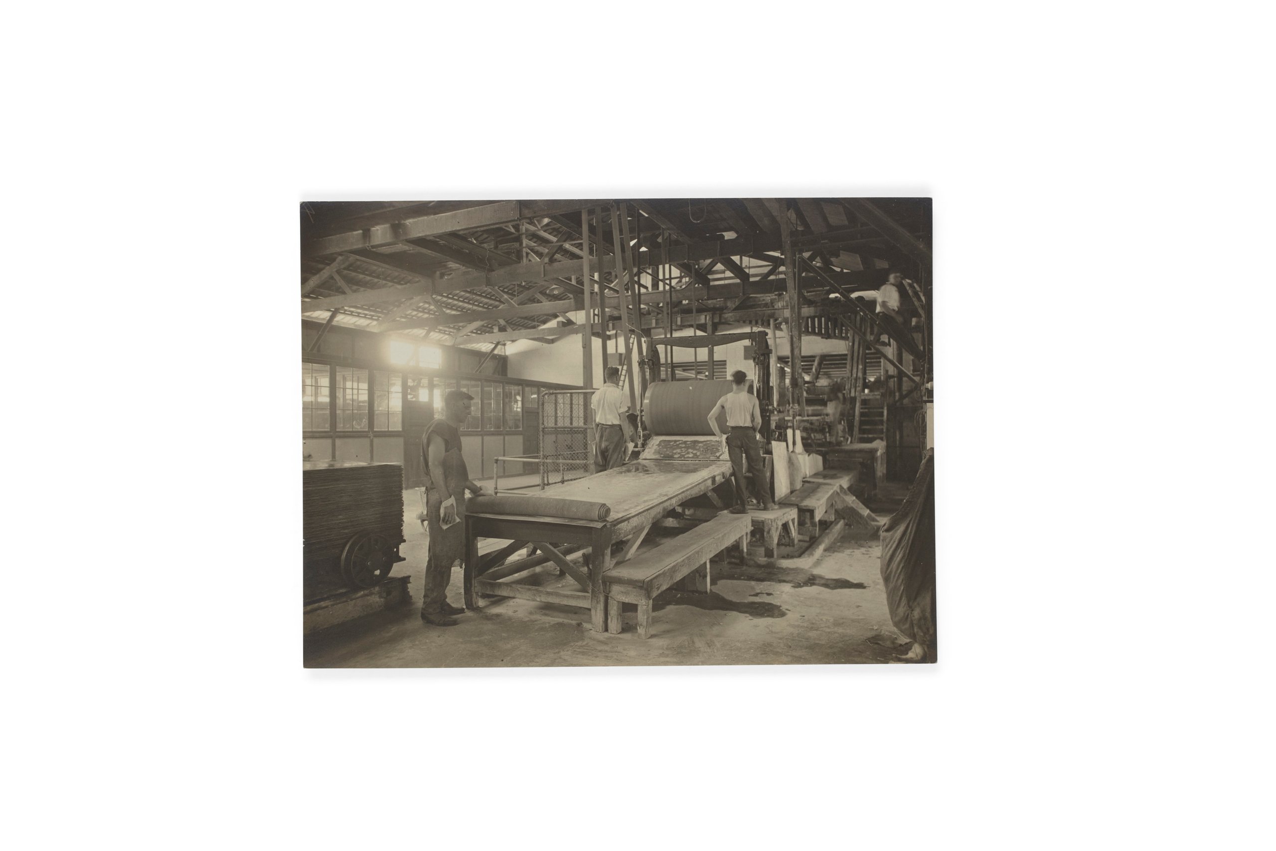 Photograph of workers rolling out Durabestos at the Wunderlich Cabarita factory