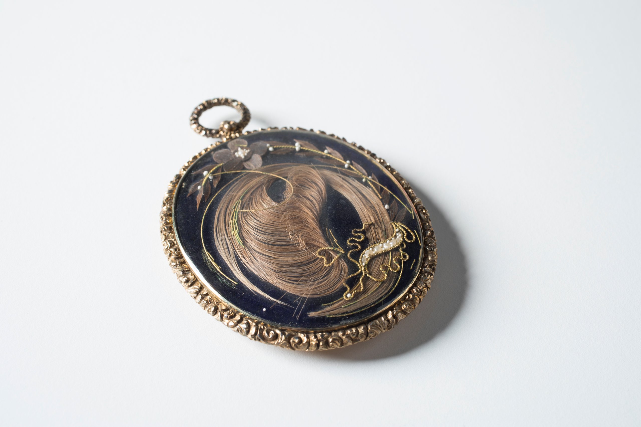 Mourning locket with hair of two sisters