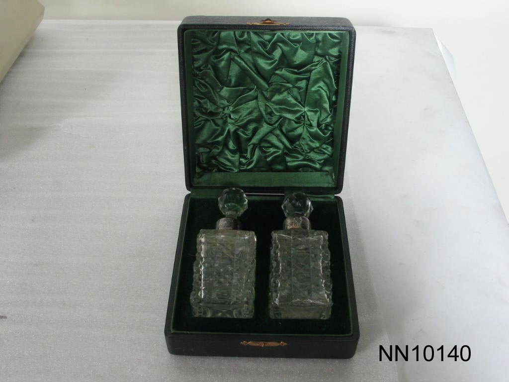 Two crystal and silver perfume bottles in case