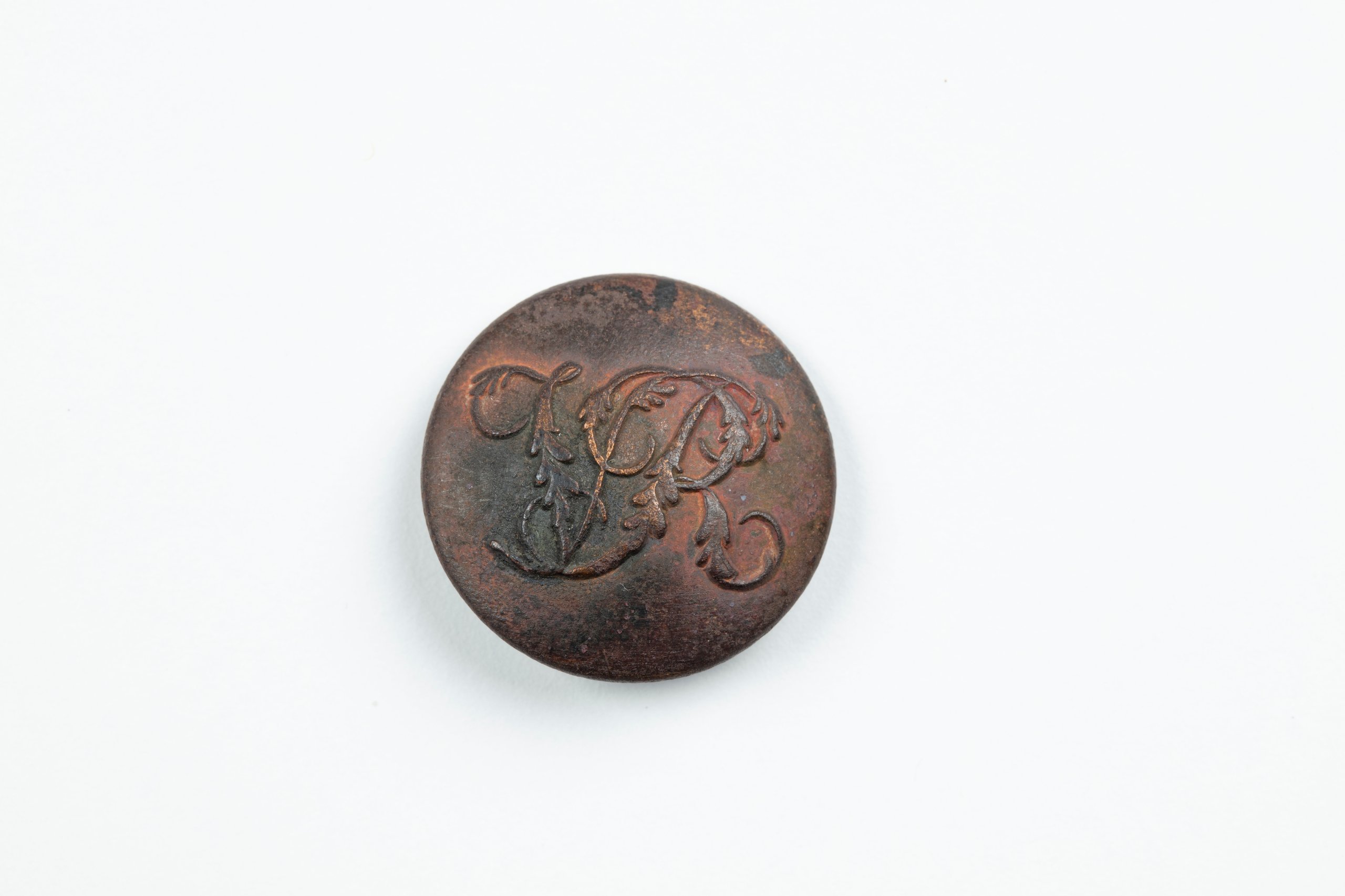 Button embossed with V R
