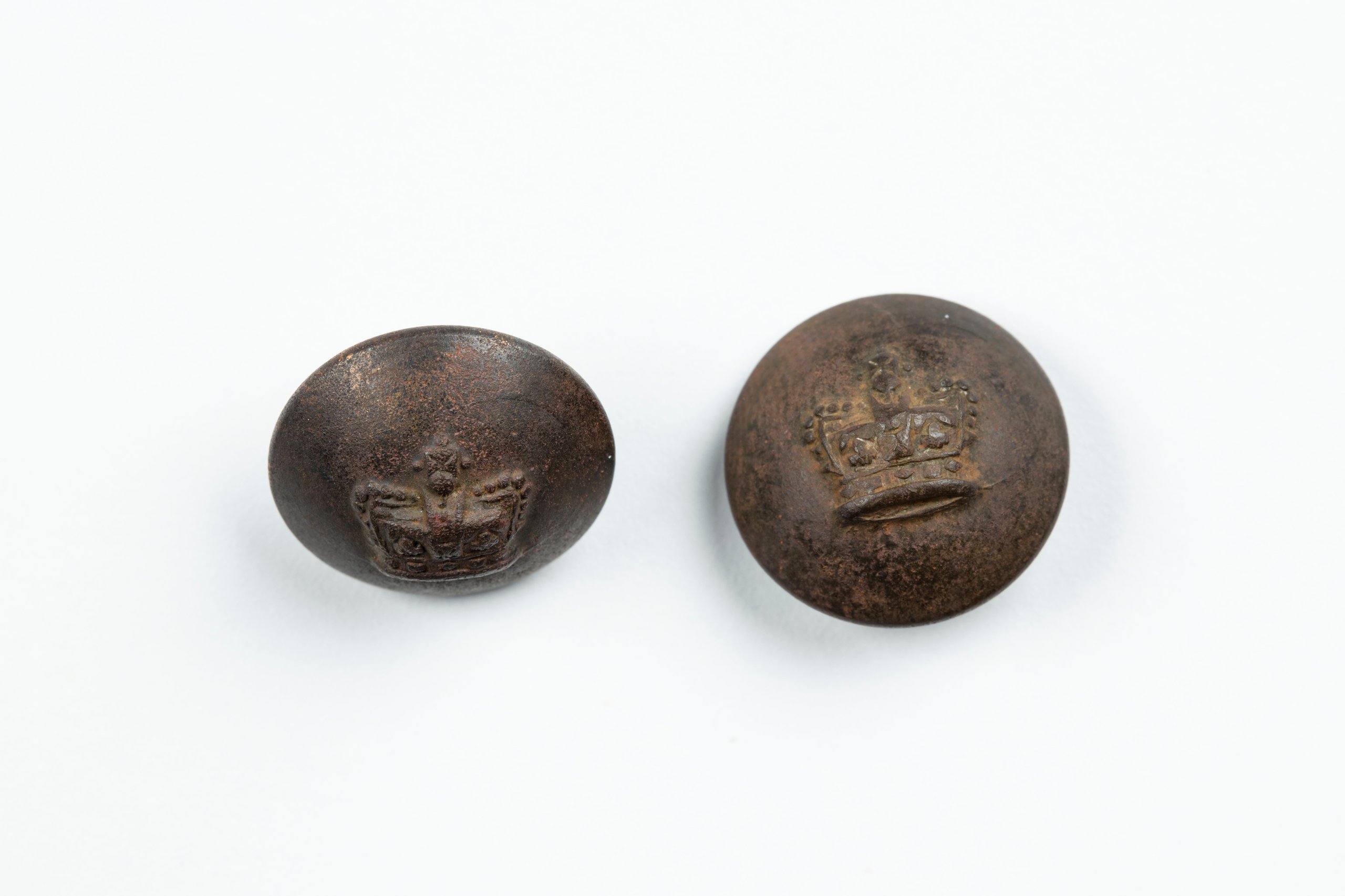 Two buttons embossed with the Queen Victoria crown