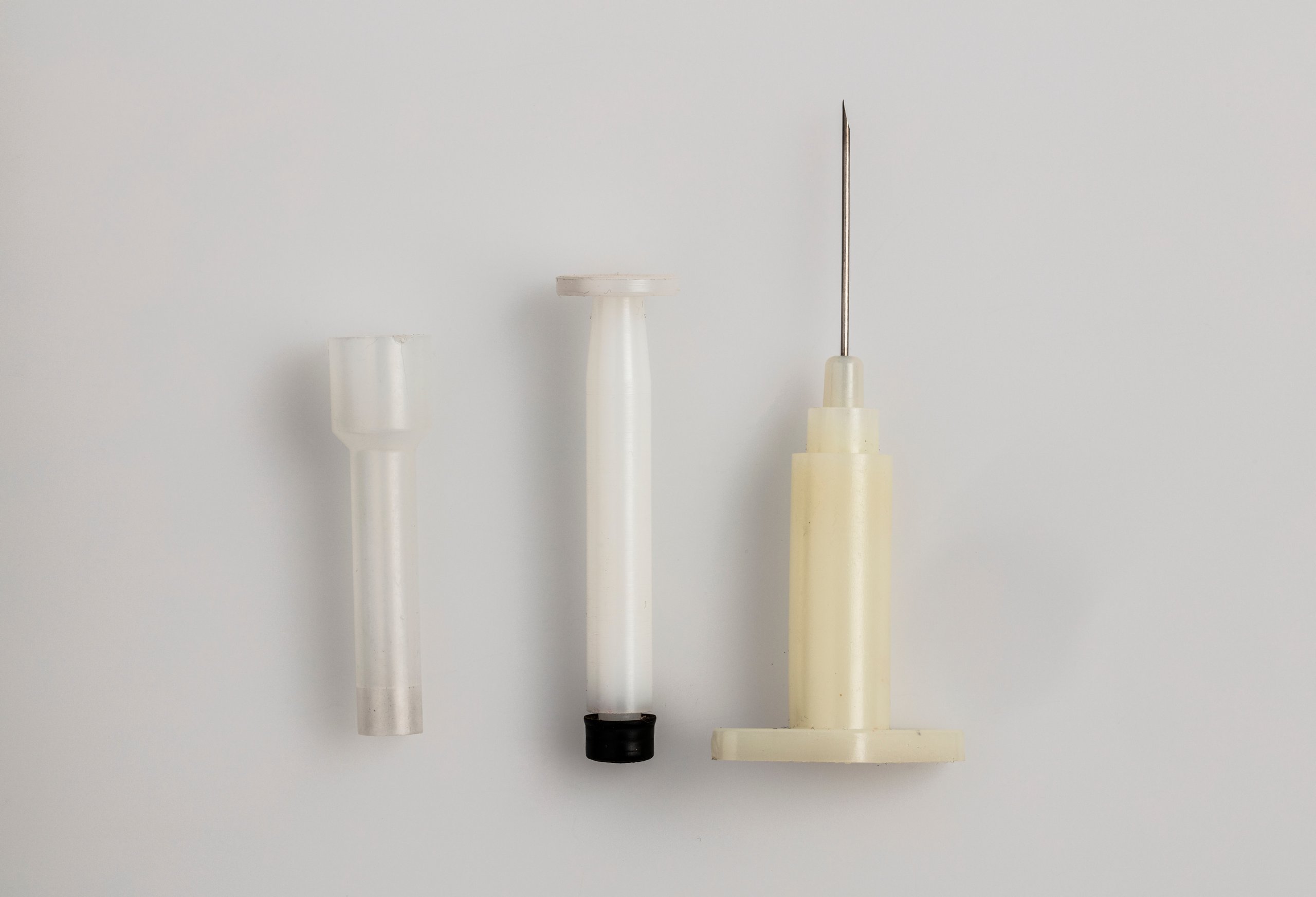 Disposable plastic syringe by Harry Whillis and Charles Rothauser