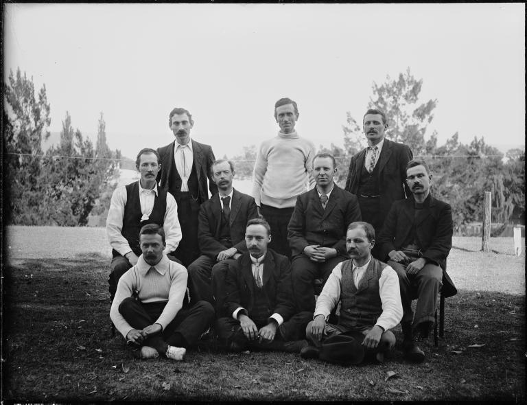 Glass plate negative of ten men posed as for a sporting photograph