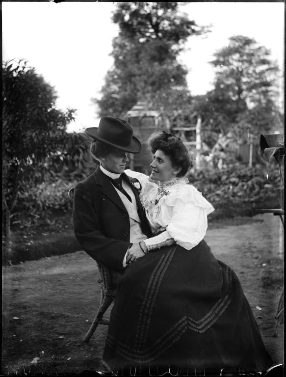 Glass plate negative of young couple seated in garden