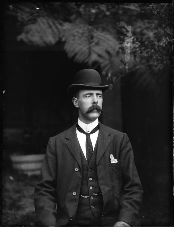 Glass plate negative of portrait of a man in suit with waistcoat