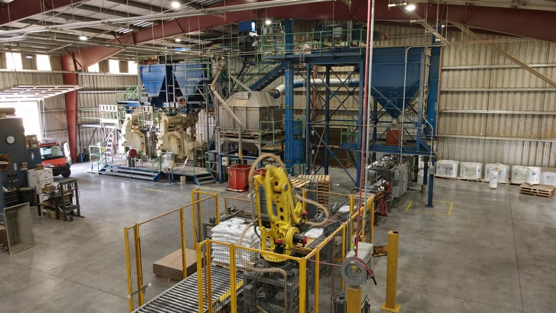 Interior view of pellet packing machinery in a warehouse