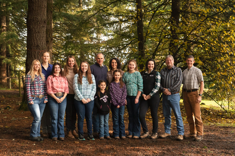Group photo of the Rogers Veterinary Service team in a forested area