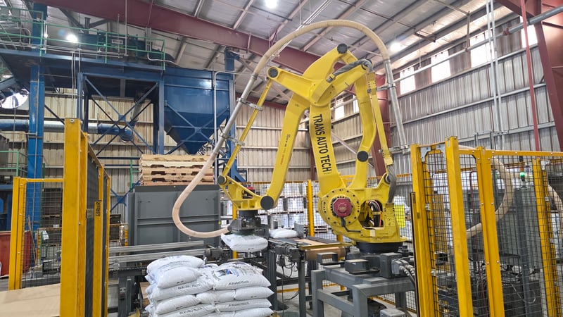 Automated robot palletizer stacker in a pellet packing facility