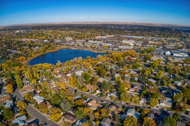 Aerial view of Thornton, Colorado, with a lake and autumn neighborhoods north of Denver.