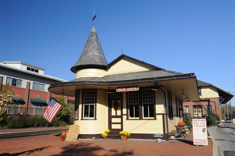 The historic New Hope train station in Bucks County, Pennsylvania, with its turret and covered platform.