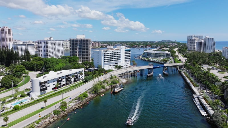 A speedboat passing a drawbridge on the Intracoastal Waterway in Boca Raton, Florida.