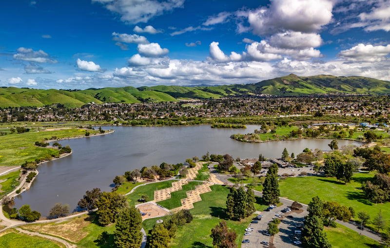 Lake Elizabeth and surrounding neighborhoods in Fremont, California, with hills in the distance.