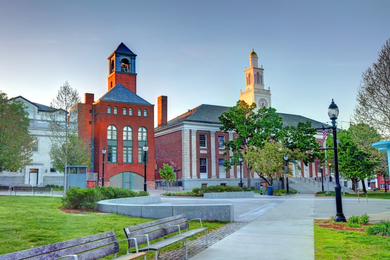 Red-brick civic buildings and the green lawn of City Hall Park in Burlington, Vermont.
